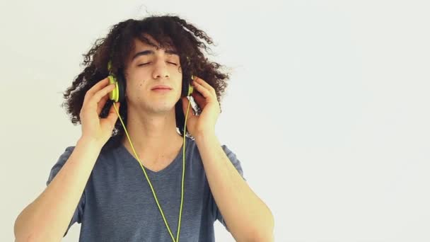 Young man listening music with headphone - Footage, Video