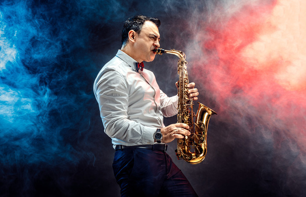 Handsome adult man playing saxophone - Zdjęcie, obraz