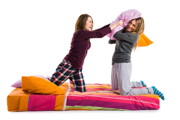 Sisters playing on bed - Фото, изображение