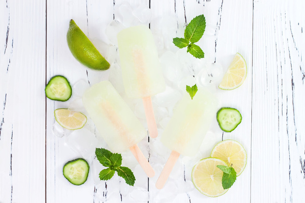 Refreshing mexican style ice pops - cucumber, lime, honeydew margarita paletas - popsicles. Top view,  overhead. Cinco de Mayo recipe, copy space - 写真・画像