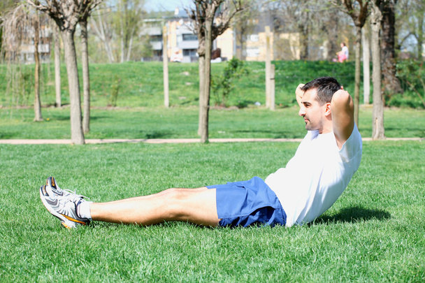 young sport man, fitness guy making push ups exercise. - Photo, Image