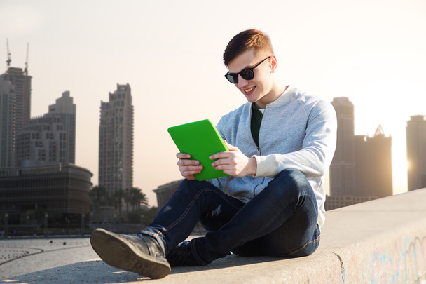 happy young man with tablet pc in city - Foto, Imagen