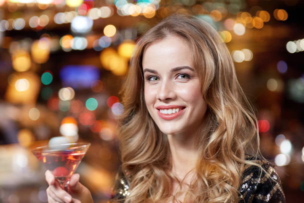 glamorous woman with cocktail at night club or bar - Photo, image