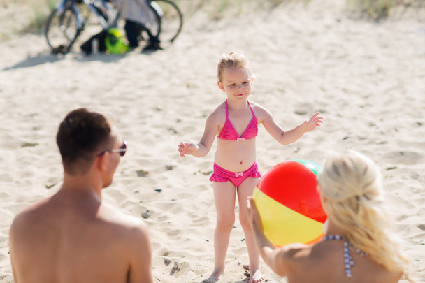 happy family playing with inflatable ball on beach - Valokuva, kuva
