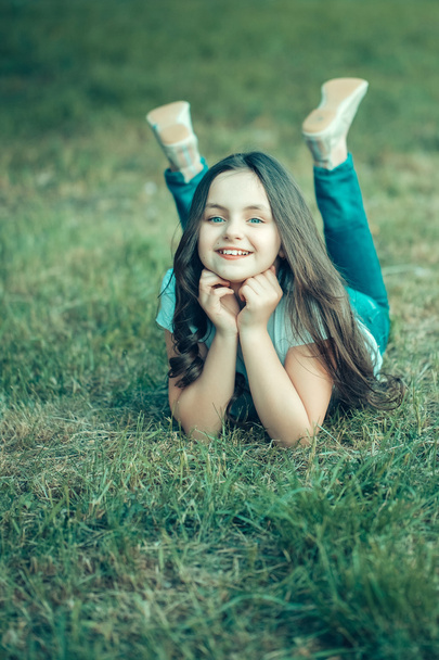 Small girl on green grass - Фото, зображення