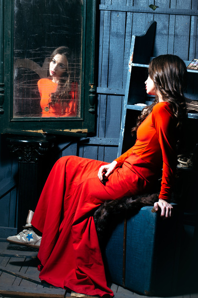 Woman in red dress near mirror - Φωτογραφία, εικόνα