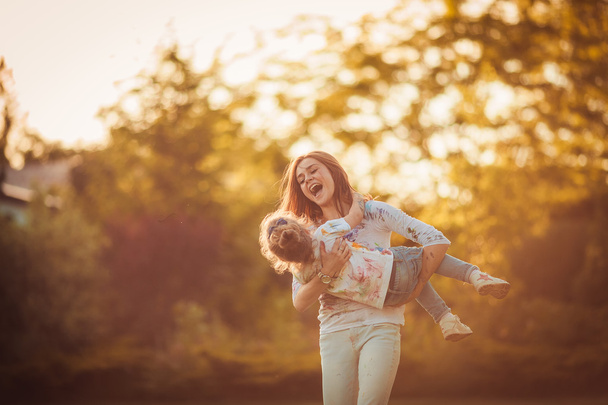 Mother and little daughter playing together - 写真・画像