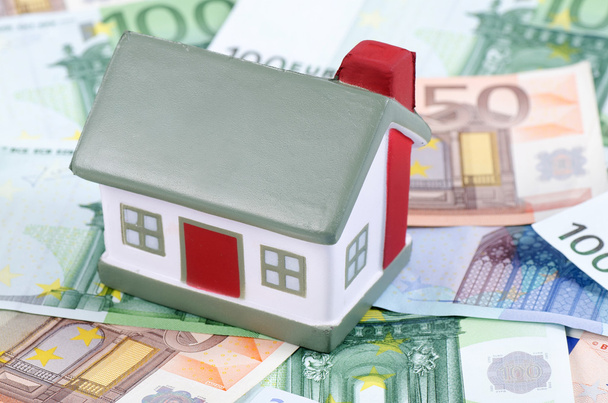 Toy house for euro banknotes as a background - Zdjęcie, obraz