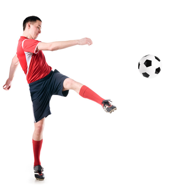 Soccer player hits the ball - Foto, afbeelding