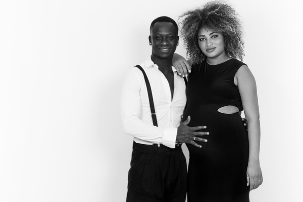 Elegant and happy couple portrait expecting baby black and white - Photo, Image