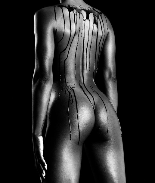 Sensual african model body covered with chocolate drops monochro - Zdjęcie, obraz