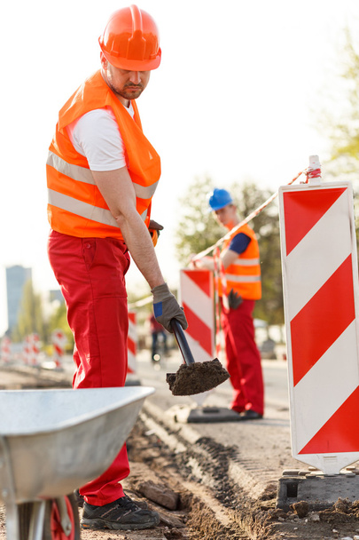 Labourer in orange safety helmet - Foto, imagen