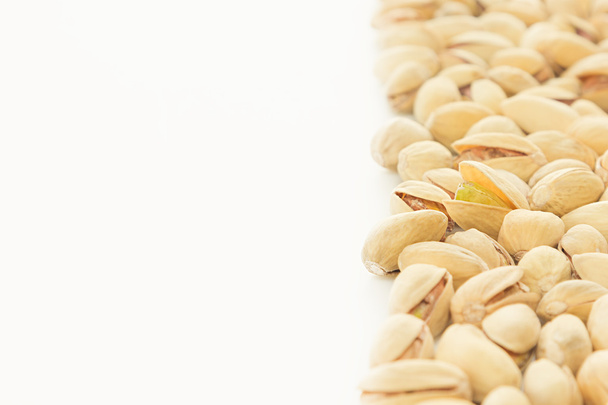 The pistachios on white background.  - 写真・画像