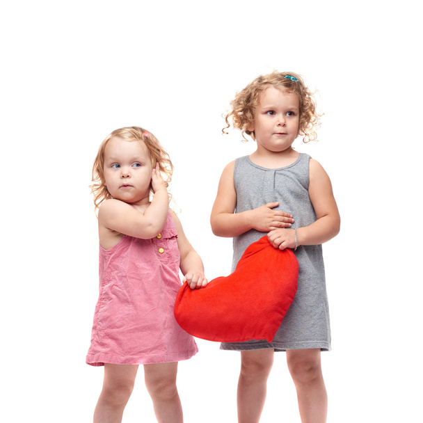 Couple of young little girls standing over isolated white background - Foto, Imagen