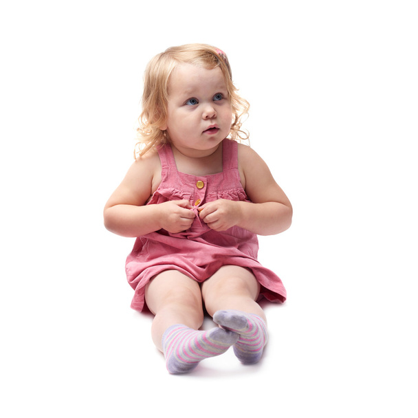 Young little girl sitting over isolated white background - Photo, image