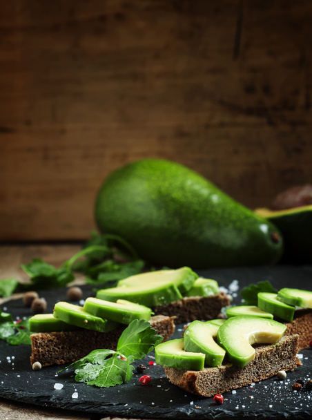 Sandwiches with avocado, black rye bread and spices - Foto, imagen