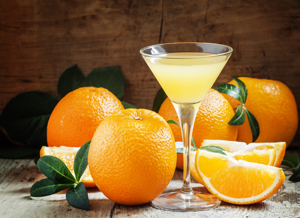 Yellow cocktail with orange juice in a martini glass - Foto, imagen