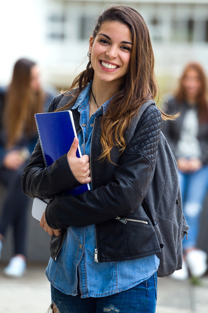 Portrait of pretty student girl in the street after class. - Zdjęcie, obraz