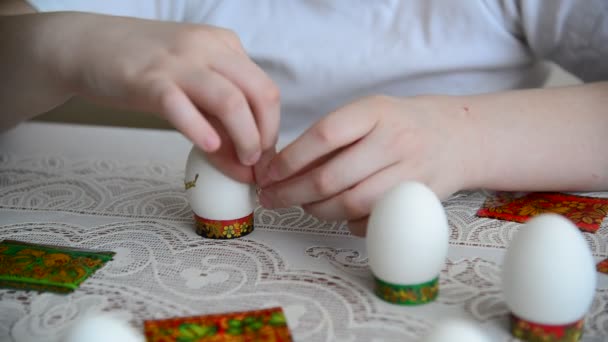 Boy sticks stickers on  Easter eggs - Filmmaterial, Video