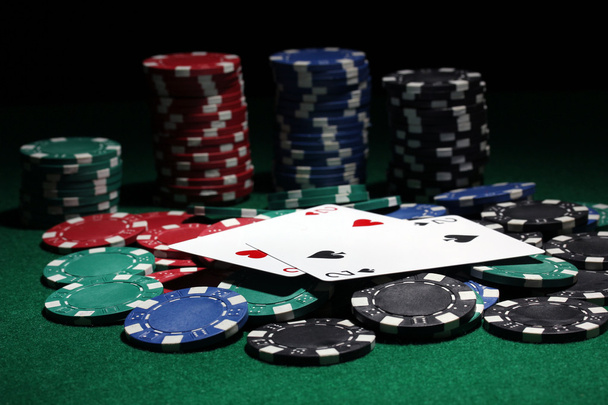 Cards and chips for poker on green table - Photo, image