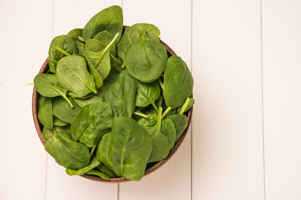 Spring spinach leaves in the bowl.  - Фото, зображення