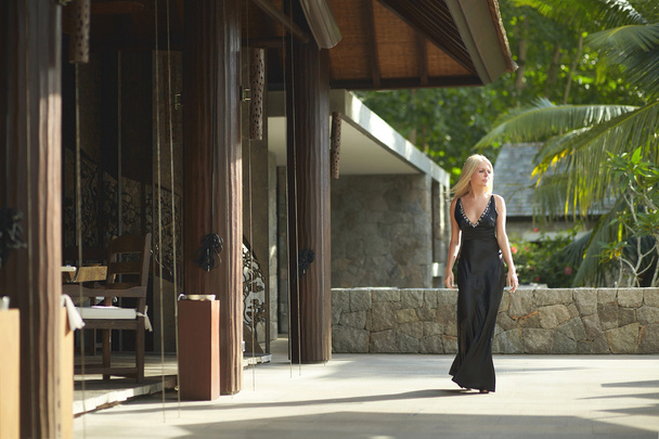 Lovely, attractive woman walking across terrace in restaurant. - Фото, изображение