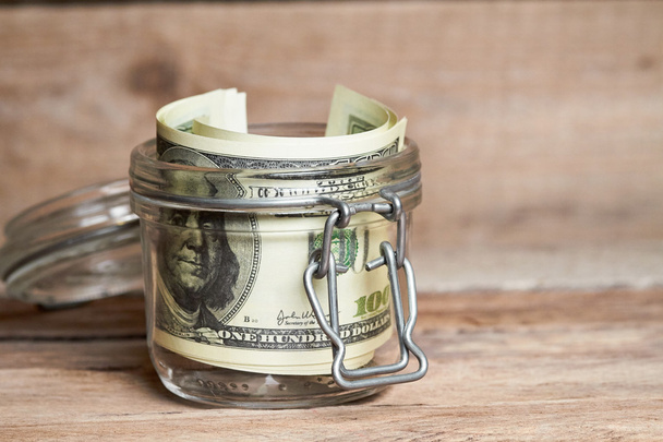 Glass jar with dollar bills - Foto, Bild