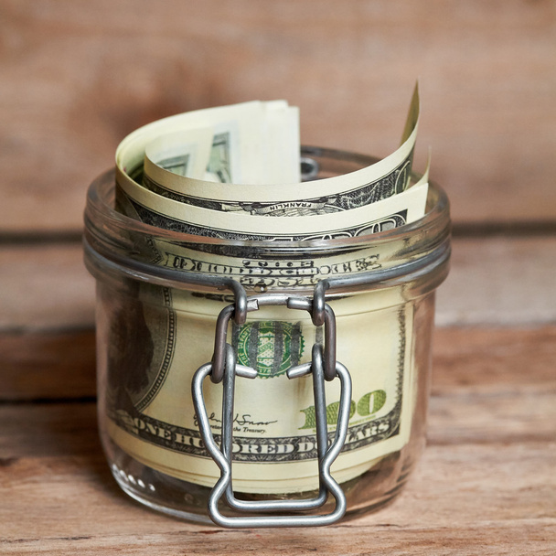 Glass jar with dollar bills - Fotografie, Obrázek
