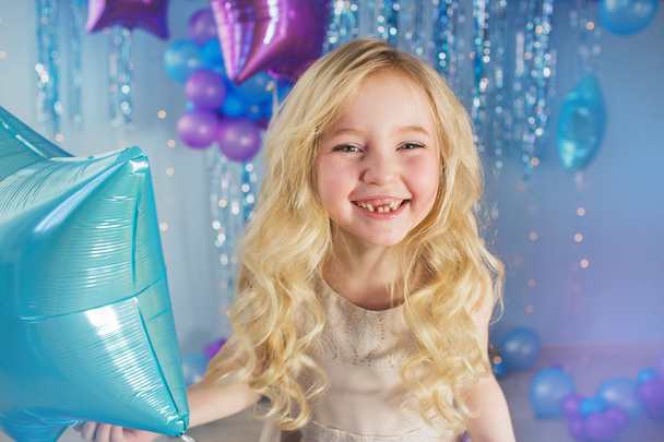 Portrait of Pretty blonde little girl with color balloons in a studio - Foto, Imagem