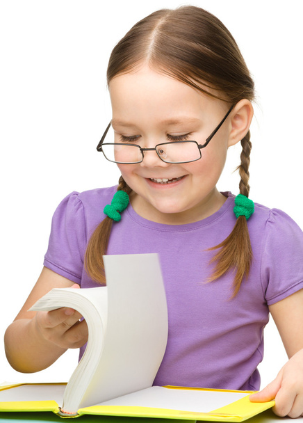 Cute cheerful little girl with book - Photo, image