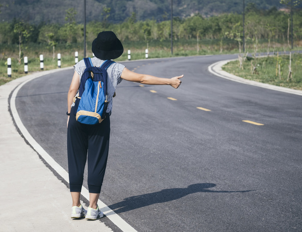 Teenager trampt mit Rucksack auf Autobahn  - Foto, Bild