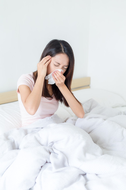 Sick woman sneezing into tissue   - Φωτογραφία, εικόνα