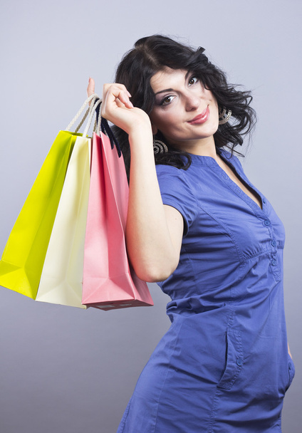Beautiful brunette with Shopping bags.Portrait of a young woman with new purchases - Photo, Image