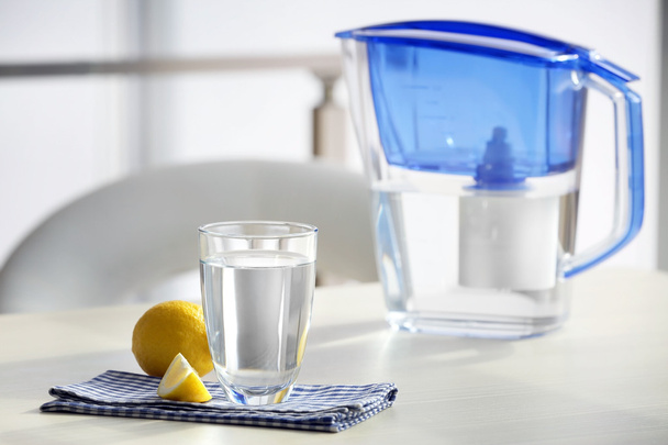 Water filter jug with lemon and glass - Fotoğraf, Görsel