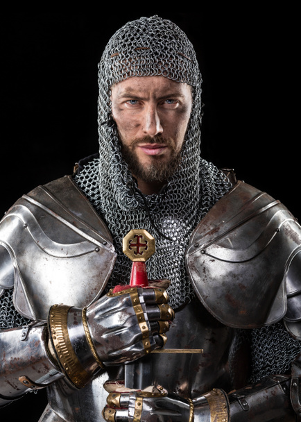 Portrait of brave man, medieval warrior or knight in armor with