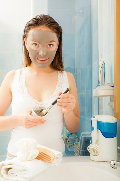 Woman applying mud facial mask - Фото, зображення