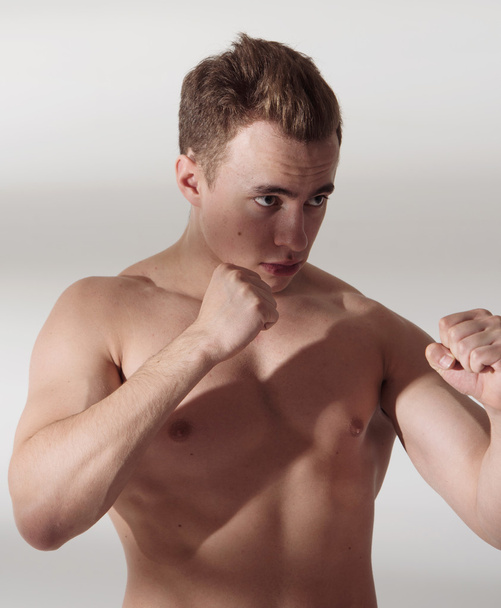 Muscular fighter man in fighting stance - Photo, image