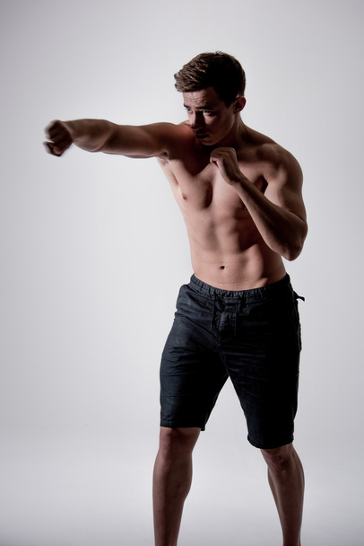 Powerful fighter man in fighting stance - Fotografie, Obrázek