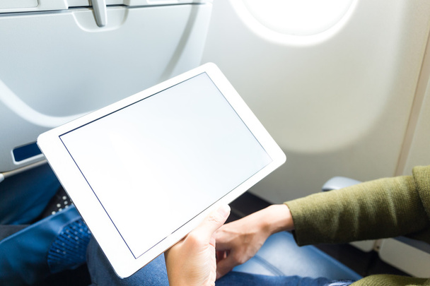 Woman holding digital tablet at airplane - Фото, изображение
