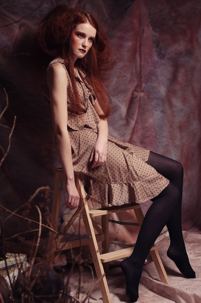 fashion model sitting on a stool - Photo, image