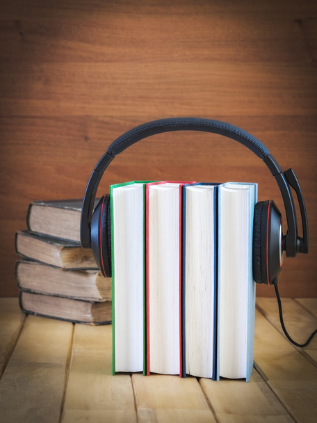 Pile of books with headphones - Фото, изображение