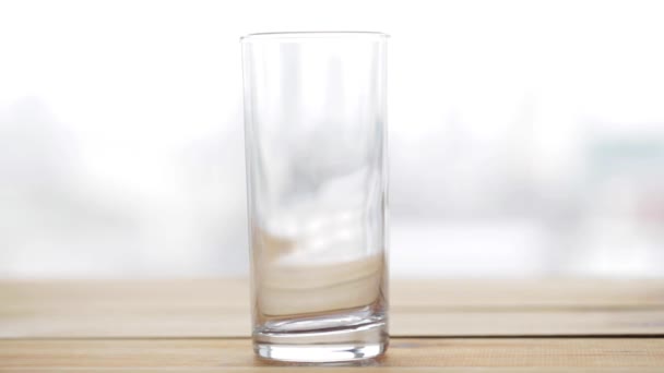 lemonade or soda drink pouring into glass on table - Materiał filmowy, wideo