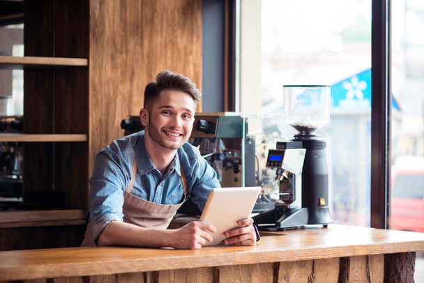 Pleasant barista standing  at the counter - 写真・画像