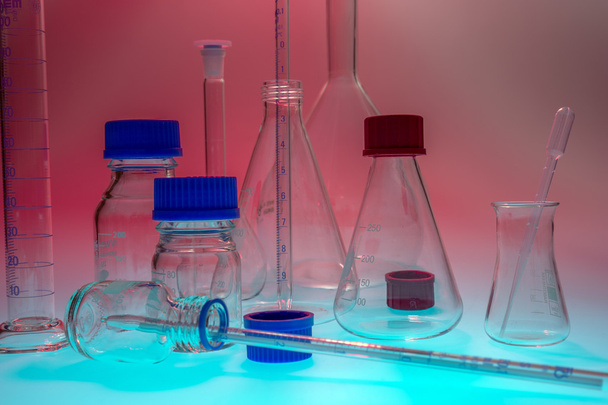 Laboratory equipment against red background - Photo, Image