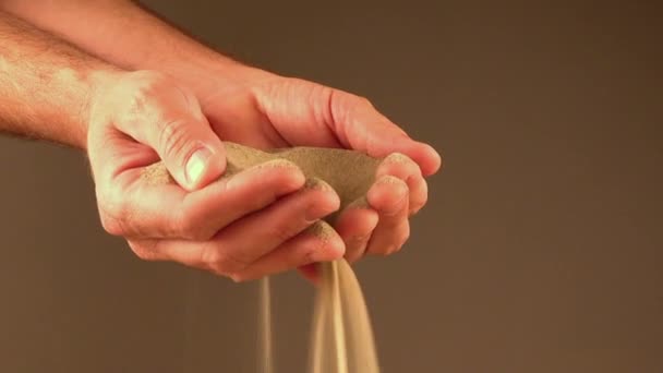 Handful of sand pouring through fingers - Footage, Video