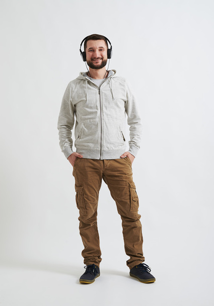 A man with headphones on his head listening music - Photo, Image