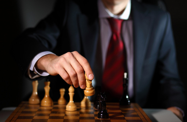 Businessman playing chess - Фото, изображение