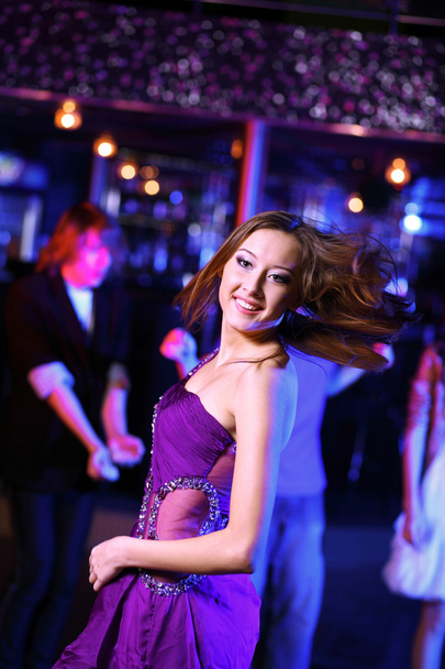 Young woman having fun at nightclub disco - Фото, изображение