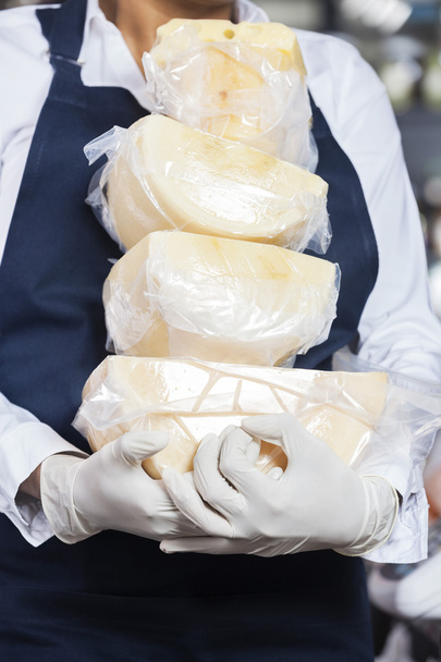 Saleswoman Carrying Cheese In Shop - Photo, image