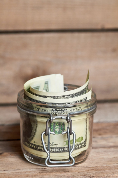 Glass jar with dollar bills - Foto, immagini